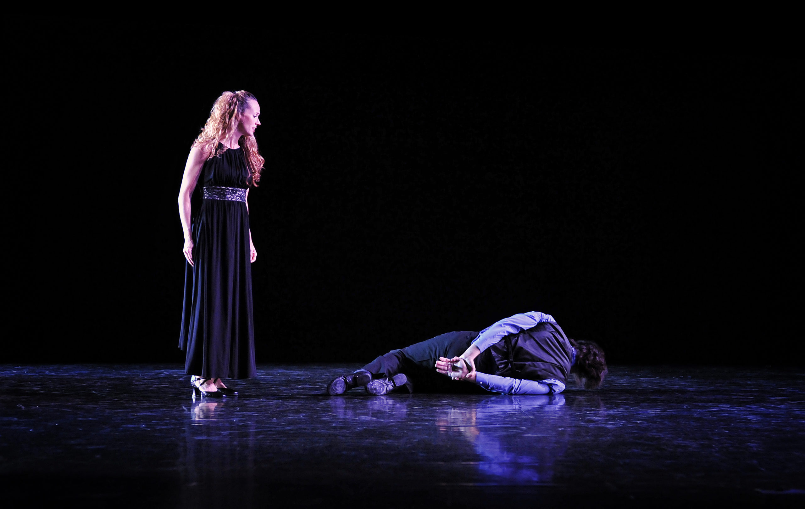 Tammy Dyke-Compton stands over Chris Compton during a performance.