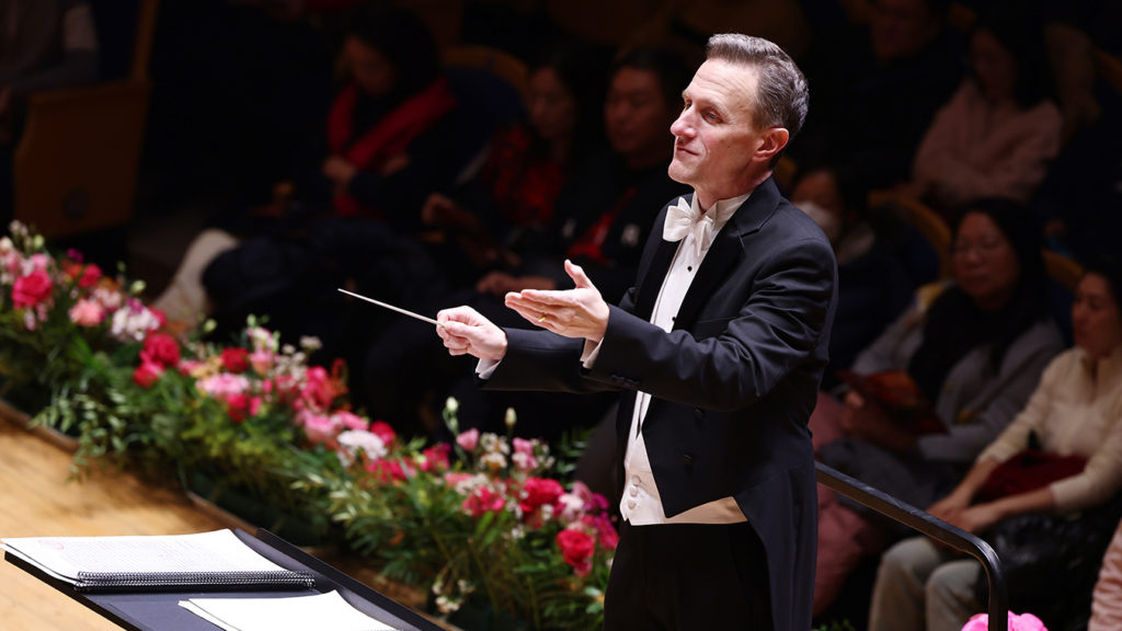 Chad Nicholson, shown here conducting an orchestra in China, was honored with the Charles and Irene Putnam Excellence in Teaching Award.