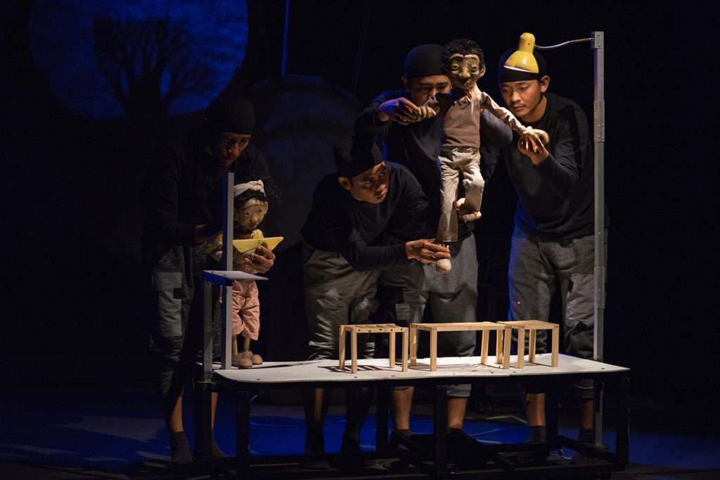 Papermoon Puppet Theatre on stage with people performing with puppets