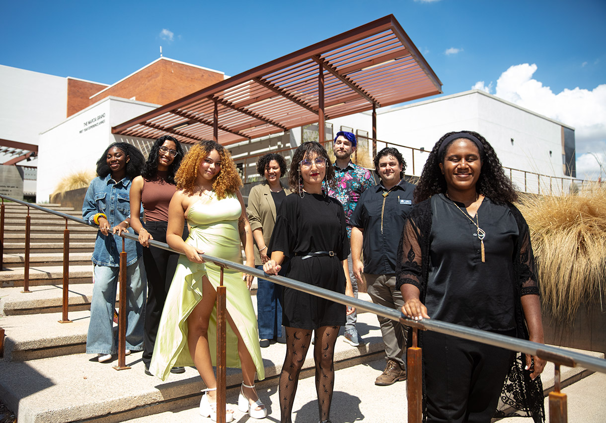 2025-26 JustArts Fellowship cohort standing outside in front of the School of Art building